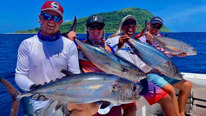 4 people holding a fish each