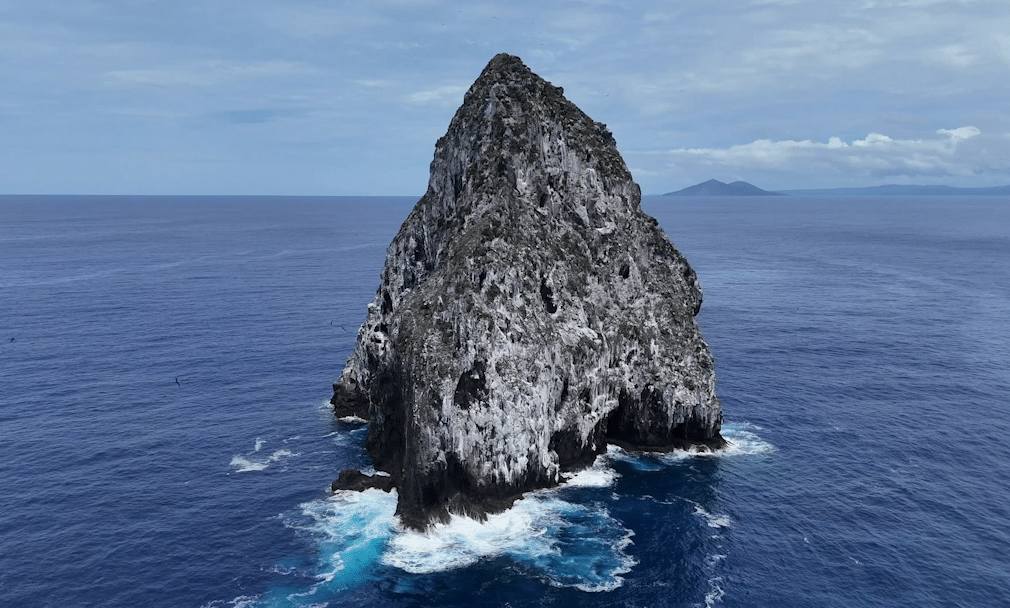 Vertical rock sea mount emerging from the depths