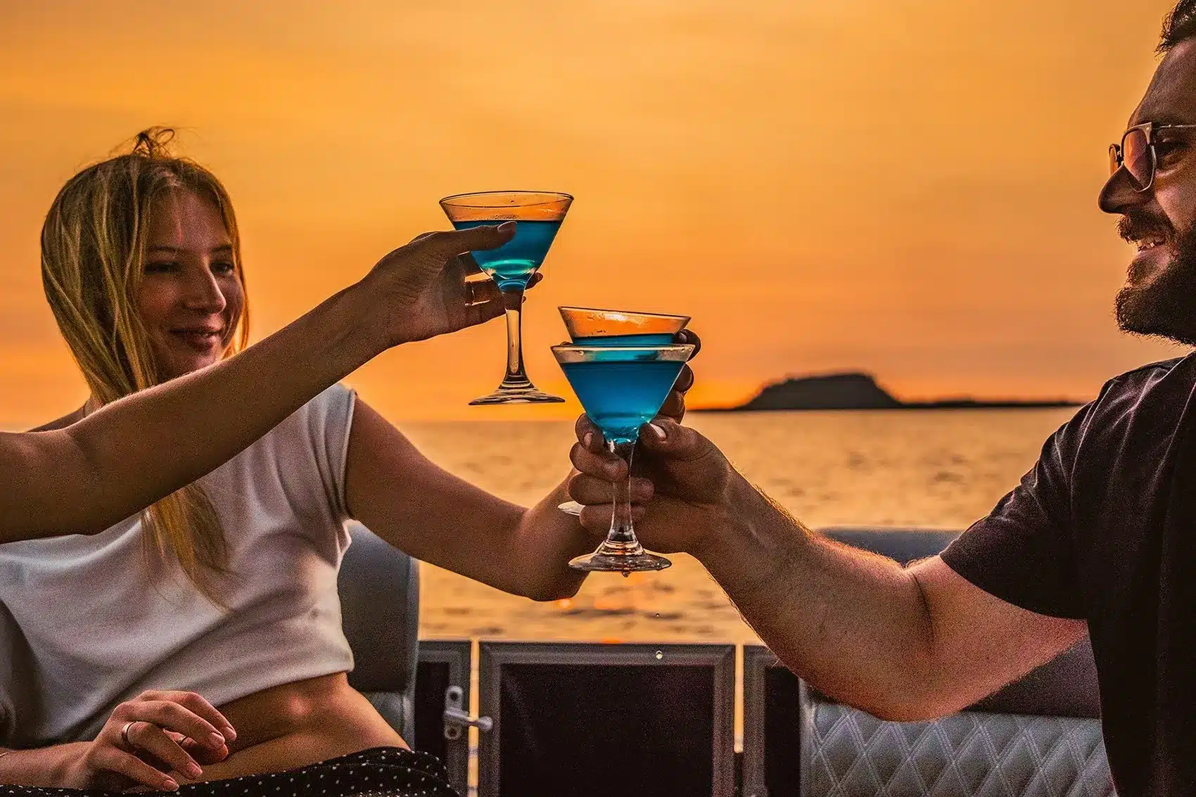 Couple relaxing on a fishing boat at sunset in Vanuatu's South Pacific waters