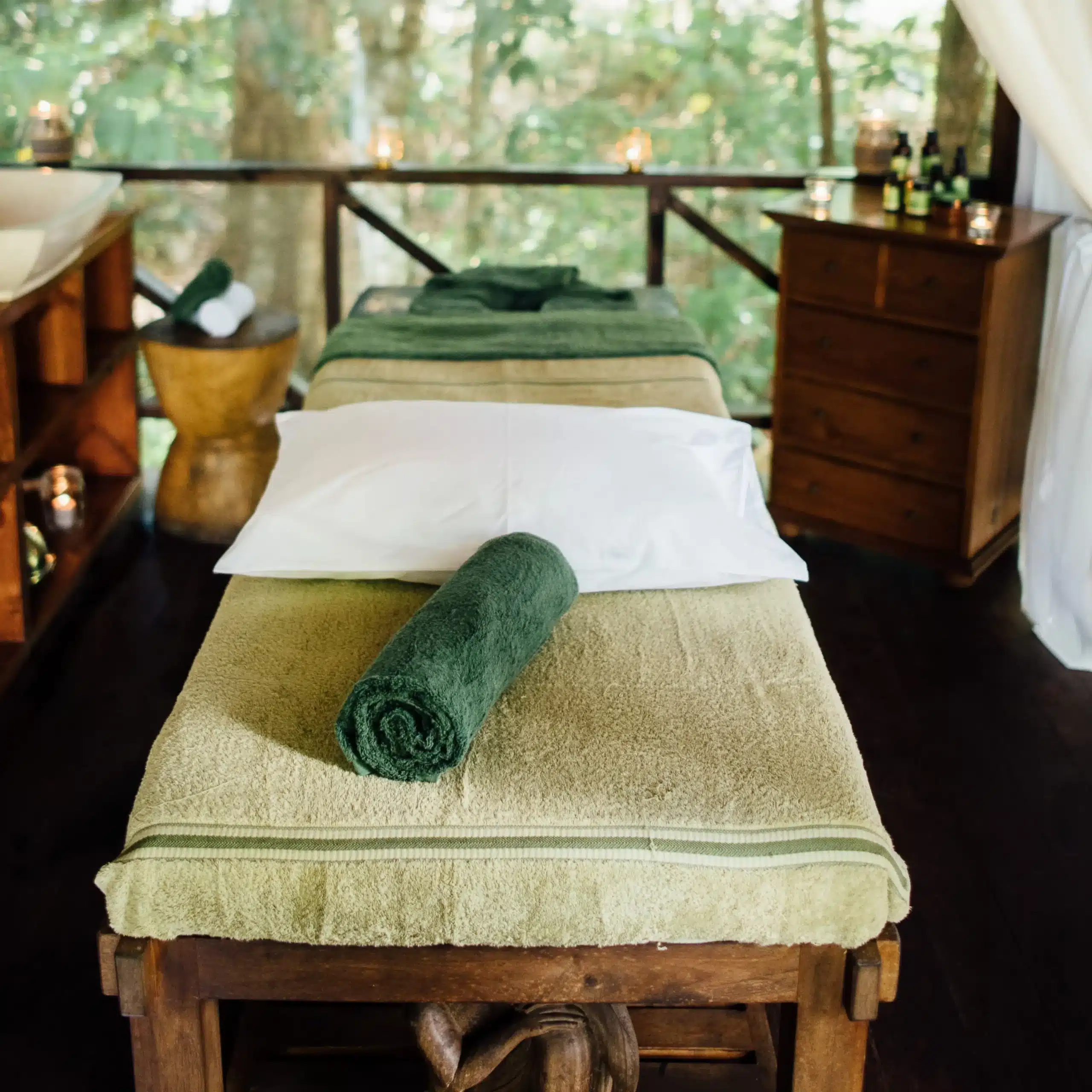 Massage bed with fresh towels set up in a tropical wellness retreat room at Trees and Fishes in Vanuatu.