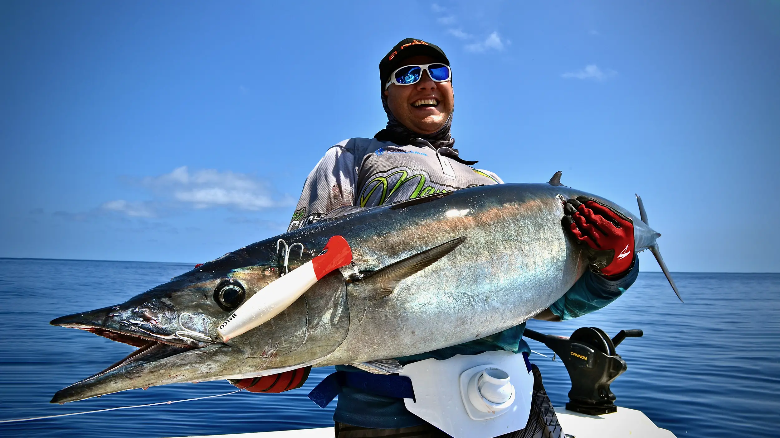 Angler proudly holding a massive wahoo caught in the pristine waters of Vanuatu during an epic fishing adventure with Ocean Blue Fishing Adventures.