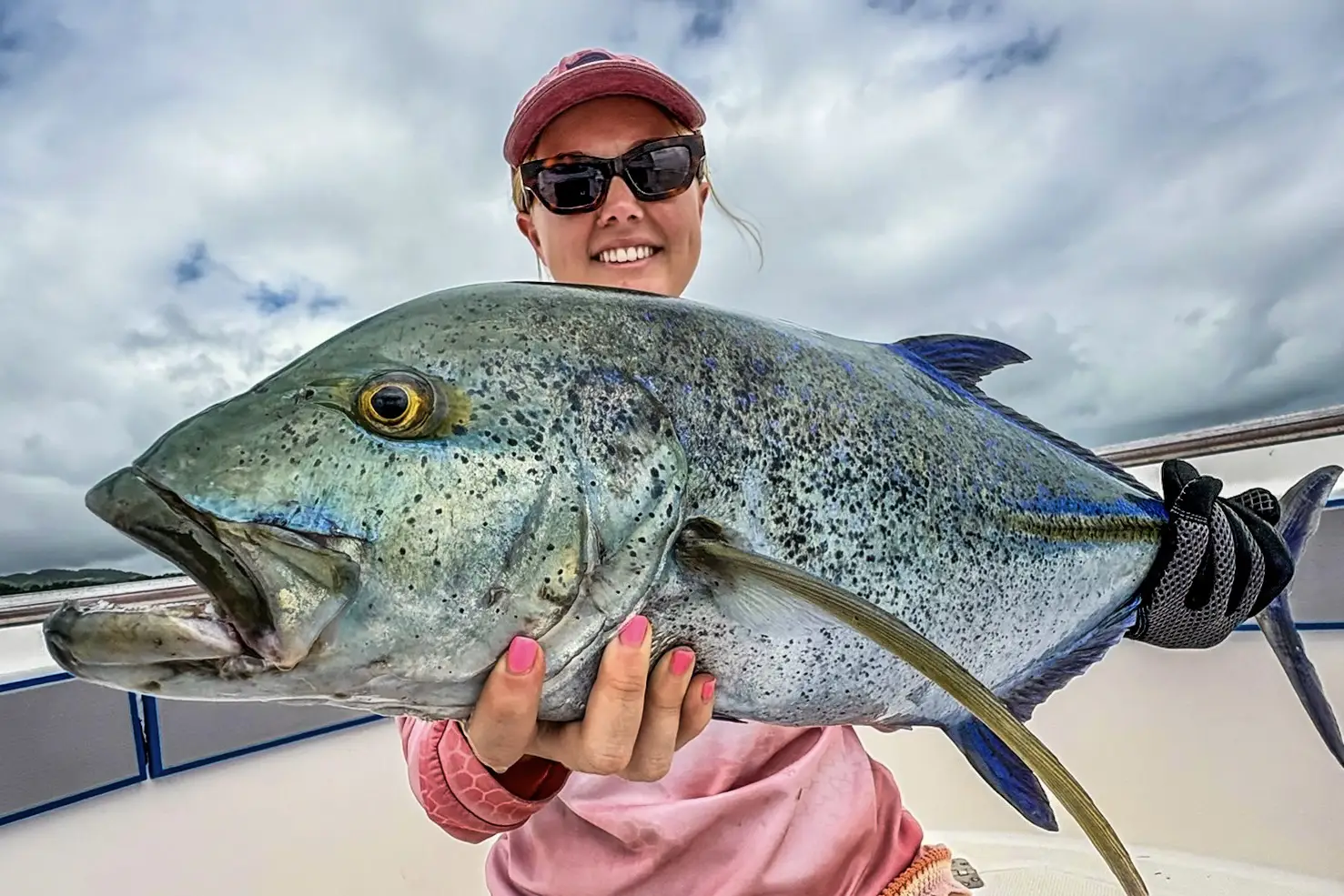 Woman holding a GT caught in Vanuatu with Ocean Blue Fishing Couples Sportsfishing Adventure