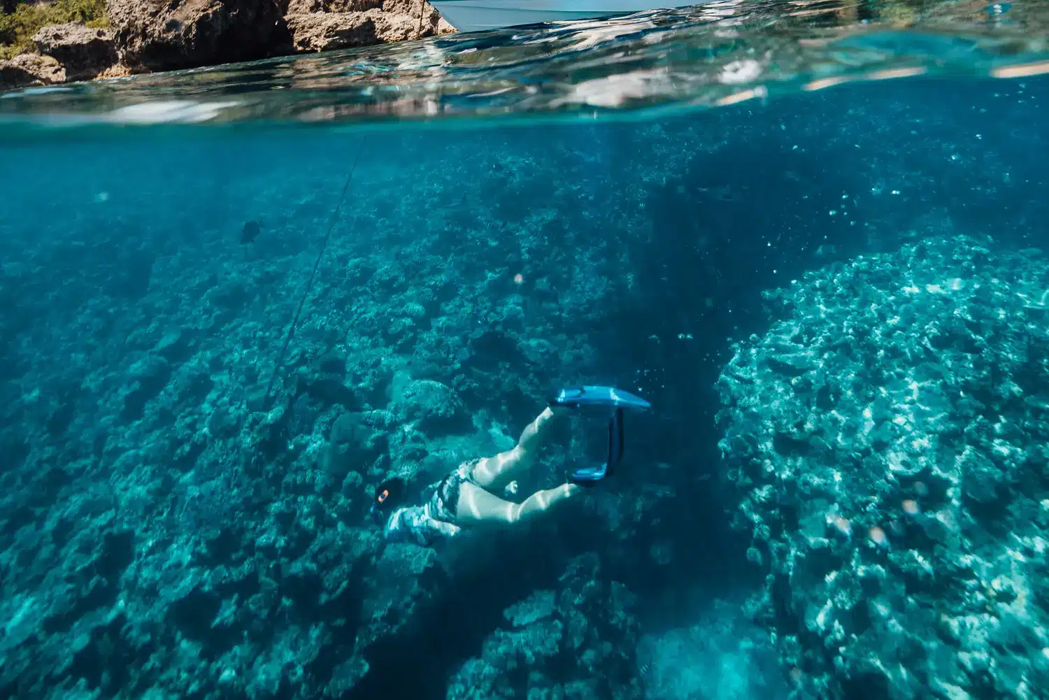 Woman snorkelling in the clear blue waters of Vanuatu surrounded by vibrant coral reefs during a Private Snorkelling Adventure with Ocean Blue Fishing